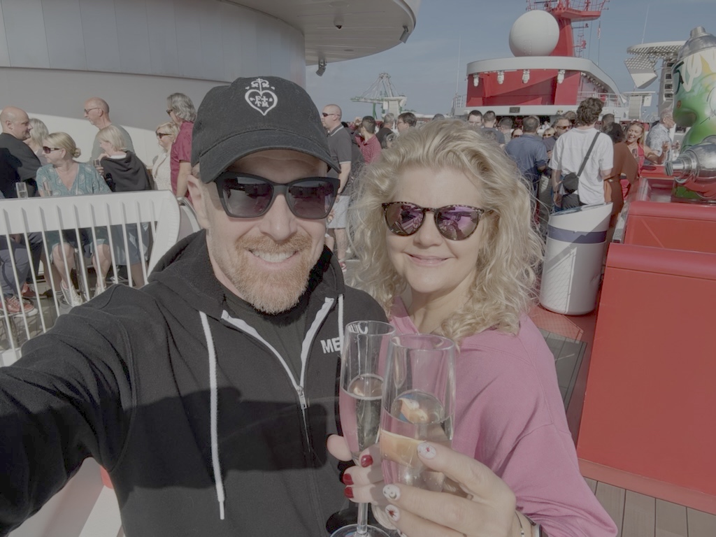 Andrew and Jen on the pool deck of Brilliant Lady with champagne on embarkation day